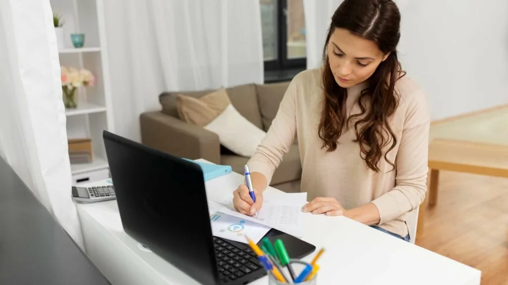 Virtual assistant bookkeeper working on a laptop
